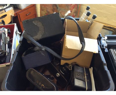 A box of camera equipment including Polaroid cameras and cases.