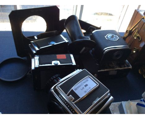 Lot to include a selection of Hasselblad camera equipment including a camera body, two winders, two plate holders, a handle a