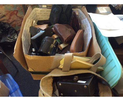 A box of camera equipment including cases, lighting fixtures etc.