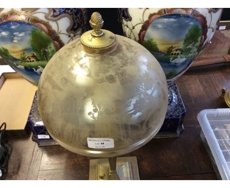 A gilt table lamp with etched glass shade.