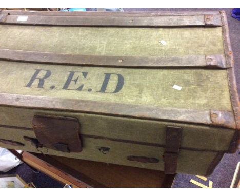 A leather bound travel trunk with the letters R.E.D.