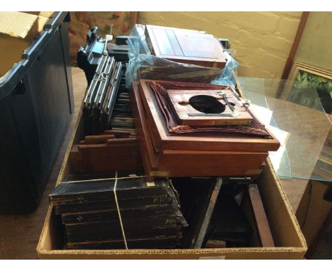 A box of wooden camera frames and camera plate holders