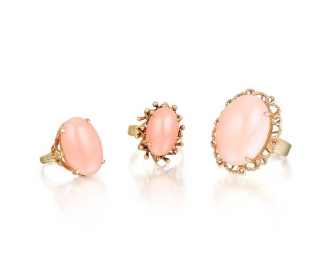 Comprising three oval-shaped cabochon coral rings, mounted in 14K yellow gold; ring sizes 5, 6-1/4, and 7; total weight 19.1 