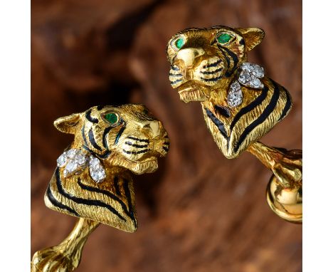 Designed as a pair of tiger cufflinks, crafted out of 18K yellow gold, with black enamel stripes and emerald eyes, further ac