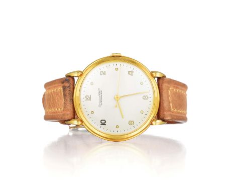 With a round 18K yellow gold case, featuring a silver dial with gold Arabic numerals and dot hour markers, and a light tan le