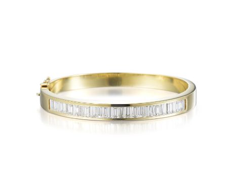 Crafted out of 14K yellow gold, set with 25 very lively channel-set baguette diamonds, weighing a total of approximately 4.00