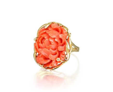 Comprising a carved flower-shaped coral, mounted in 14K yellow gold; ring size 7-1/4; ring top measures 2.0 x 2.5 cm, with a 