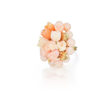 Designed as a coral ring, carved in the shape of a bouquet, with multiple beads and flower buds, accented with yellow gold le