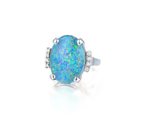 Set with an oval-shaped doublet opal, flanked by eight round brilliant-cut diamonds, weighing a total of approximately 0.15 c