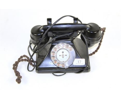 A vintage black rotary dial telephone