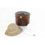 A tin hat box with original early polo helmet and an early pith helmet