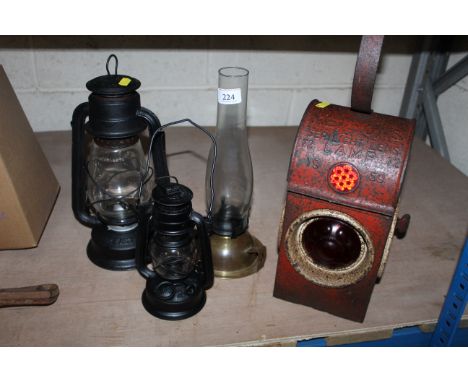 Three oil lamps and a Kenyons Serilight lamp dated for 1959