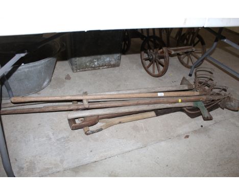 A quantity of wooden long handled gardening tools to include tined cultivators, spade, forks, hoe etc.