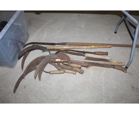 A quantity of wooden handled tools to include sickles, long handles slashers etc.