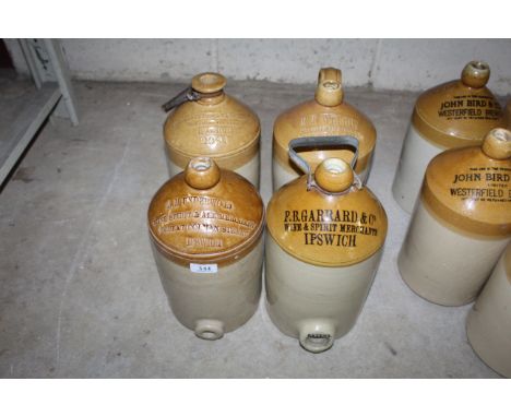 Four stoneware flagons, three with handles and two with pourers, named to "A.M. Underwood", "P.B. Garrard &amp; Co.", "Bridge