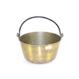 A large brass jam pan with metal swing handle