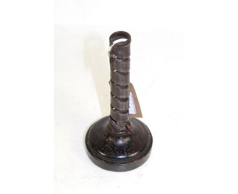 An 18th Century wrought iron spiral candlestick on a fruit wood base