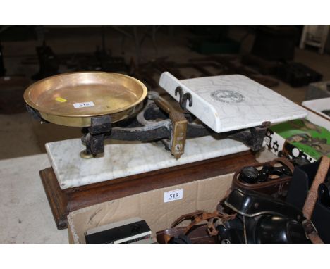 A set of grocery scales with heavy brass pan, named to Parnall &amp; Sons Ltd. of Bristol marked 19806, mounted to marble top