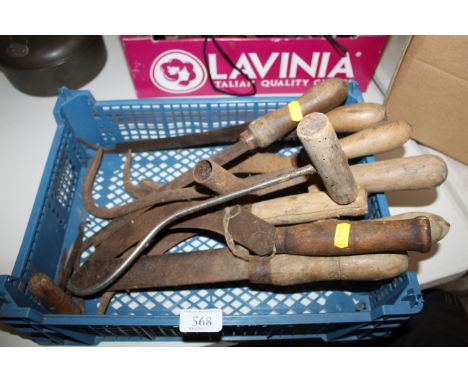 A box containing a small quantity of hand tools to include a beet hook, sickle etc.