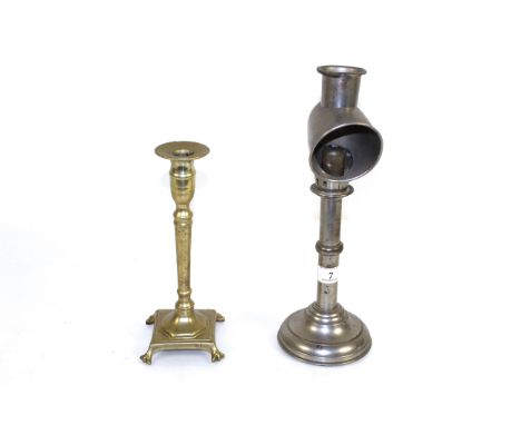 A students nickel plated candle lamp and a brass candle holder