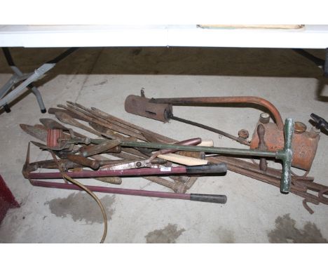 A quantity of various tools to include cast iron dibbers, long handled shears, rotary lawn edger, pressurised weed burner, me
