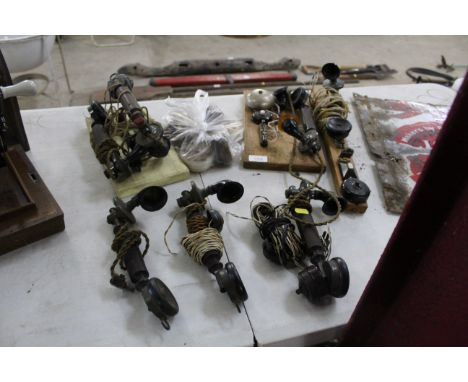 A quantity of vintage telephone handsets, some mounted to wooden boards