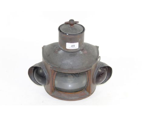 An unusual copper hanging or fixed paraffin operated lamp with red and green glass indicators to the side and clear glass lam