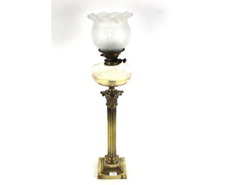 A 19th Century Corinthian column brass oil lamp with ornate brass shade and glass reservoir