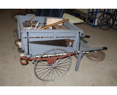 A 1920's / 1930's decorators barrow with spoke wheels including contents of builders and decorators tools, steps etc.