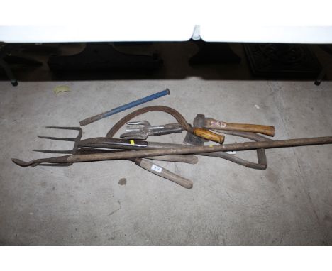 A quantity of various garden tools to include axe, scythe, digging fork, garden hoe, shears etc.