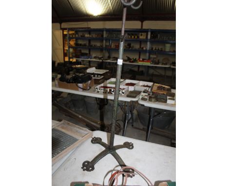 A vintage "Wiltshire" bicycle stand with four ornate feet and adjustable centre column named to Victorian Hutton &amp; Co. of