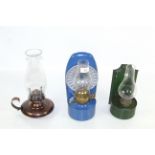 Three various paraffin lamps with chimneys
