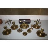 A large collection of antique and vintage brass chamber sticks, tinware candle box, brass snuffer
