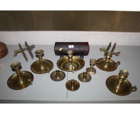 A large collection of antique and vintage brass chamber sticks, tinware candle box, brass snuffer stand and two pairs of bras