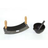 A cast iron pestle and mortar and a large herb cutter