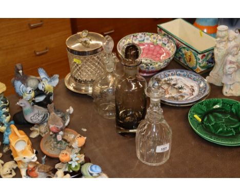 A cut glass decanter and stopper; a smoked glass decanter; a claret jug; and a glass and silver plate mounted biscuit barrel