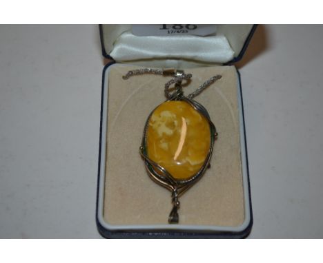 A large Art Deco style butterscotch amber pendant on chain, total weight approx. 18gms 
