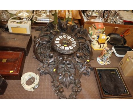 A large Black Forest type wall clock decorated fruit, foliage and animals AF