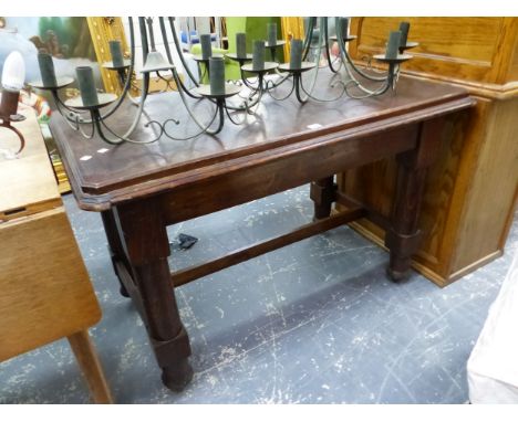 AN OAK TABLE WITH SUBSTANTIAL CYLINDRICAL LEGS