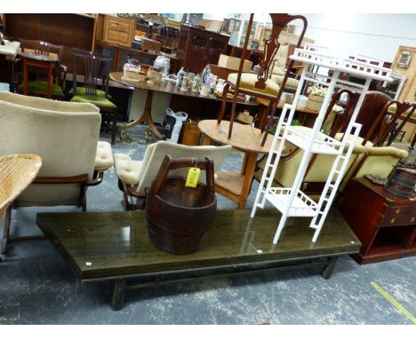 A YELLOW GRAINED BLACK WOOD COFFEE TABLE WITH TRAPEZOIDAL TOP TOGETHER WITH A WHITE PAINTED THREE TIER STAND