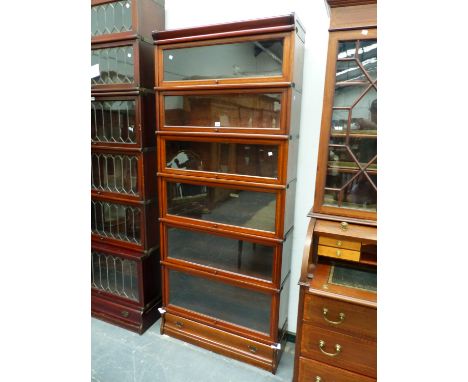 A BAND INLAID MAHOGANY GLOBE WERNICKE SIX SHELF CABINET WITH BASAL DRAWER