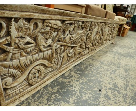 A BURMESE CREAM PAINTED PANEL CARVED WITH FIGURES AND CHARIOTEERS