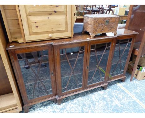 A CROSS BANDED MAHOGANY BREAKFRONT DISPLAY CABINET ON BRACKET FEET
