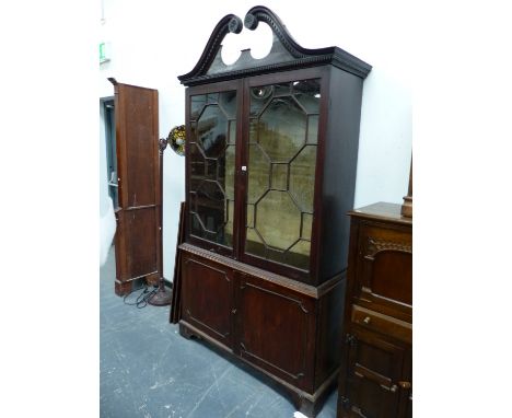 AN 18th C. MAHOGANY DISPLAY CABINET, THE SWAN NECK TOP ABOVE ASTRAGAL GLAZED   AND PANELLED DOORS ON BRACKET FEET.   W 125 x 