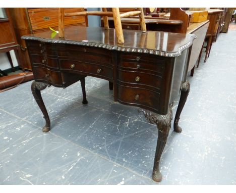 A MAHOGANY FIVE DRAWER TABLE, THE GADROONED EDGE TOP ABOVE LEATHER INSET WRITING SLIDE AND A BRUSHING SLIDE