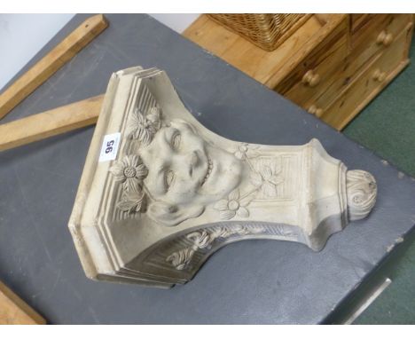 A STONEWARE WALL BRACKET CAST WITH A MANS FACE