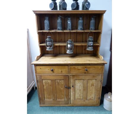 A PINE DRESSER WITH ENCLOSED TWO SHELF BACK, THE BASE WITH TWO DRAWERS AND DOORS.   W 125 x D 55 x H 175cms.