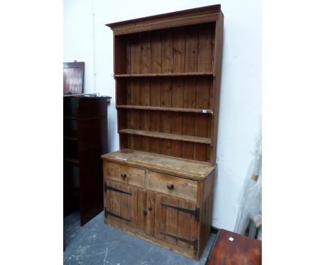 A PINE DRESSER, THE ENCLOSED SHELF BACK ABOVE TWO DRAWERS AND TWO PLANK BUILT DOORS