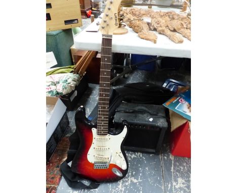 AN ELECTRIC GUITAR AND A SMALL AMPLIFIER. 