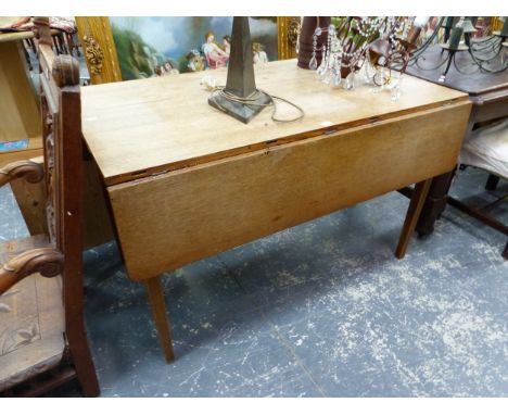AN OAK DROP FLAP DINING TABLE ON TAPERING SQUARE LEGS
